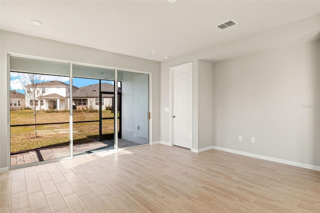 spare room with light hardwood / wood-style flooring