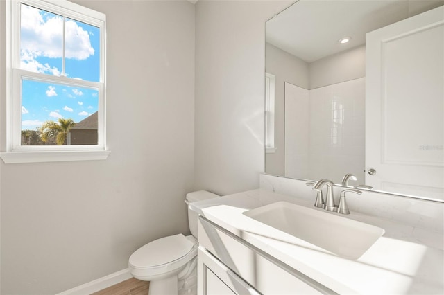 bathroom featuring vanity, toilet, and hardwood / wood-style floors