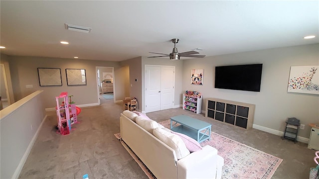 living room with ceiling fan and light colored carpet