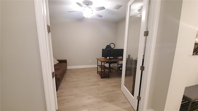 office area with ceiling fan and light hardwood / wood-style floors