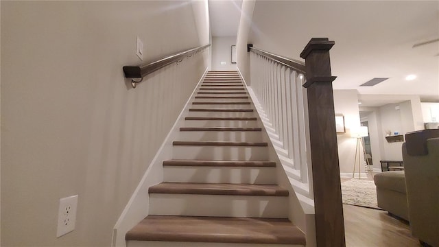 stairs with wood-type flooring