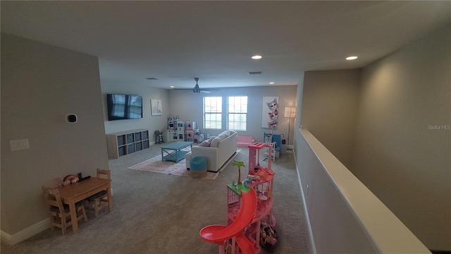 living room with ceiling fan and carpet floors