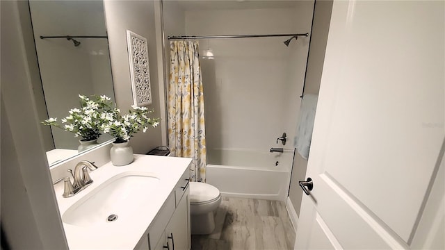 full bathroom with hardwood / wood-style floors, vanity, toilet, and shower / tub combo with curtain