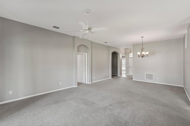 empty room with carpet flooring and ceiling fan with notable chandelier