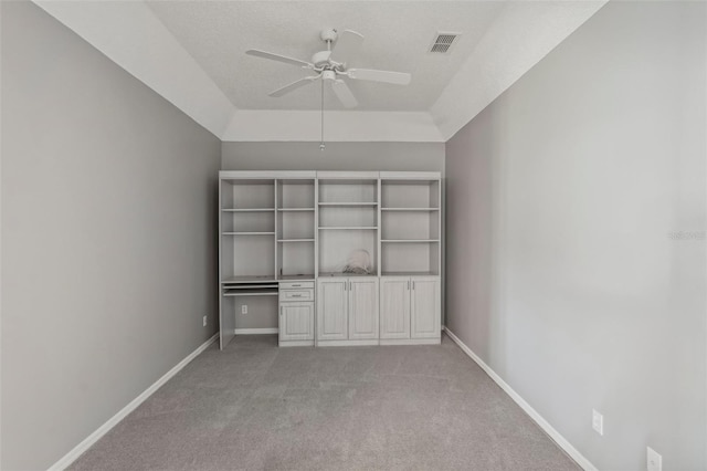 unfurnished bedroom with a textured ceiling, carpet floors, a closet, and ceiling fan