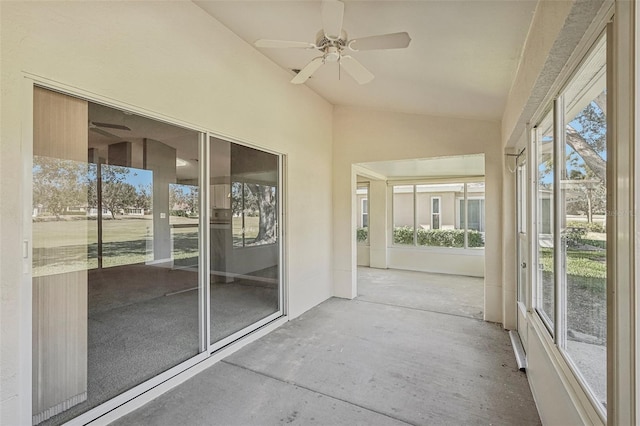 unfurnished sunroom featuring ceiling fan and vaulted ceiling