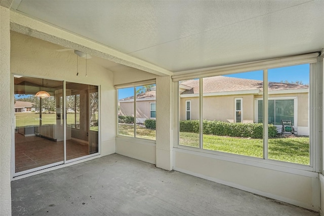 unfurnished sunroom featuring lofted ceiling