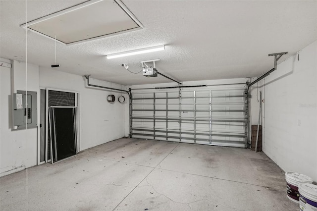 garage with electric panel and a garage door opener