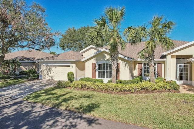 view of front of property with a garage and a front lawn