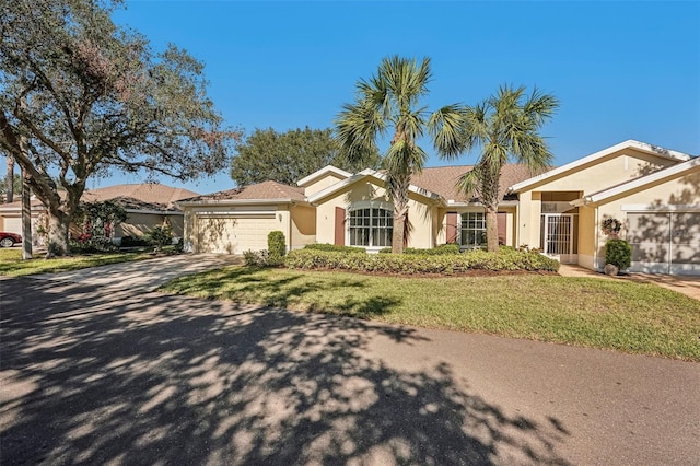 ranch-style home with a garage and a front yard