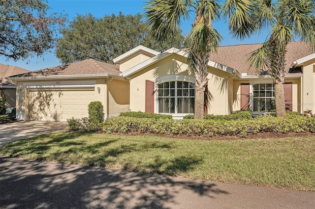 ranch-style home featuring a front lawn and a garage