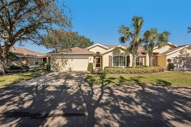 view of front of home featuring a front lawn and a garage