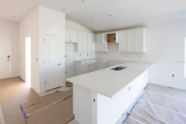 3430 Sarto Ln, Rotonda West, FL 33947 - kitchen featuring vaulted ceiling, white cabinetry, and a peninsula