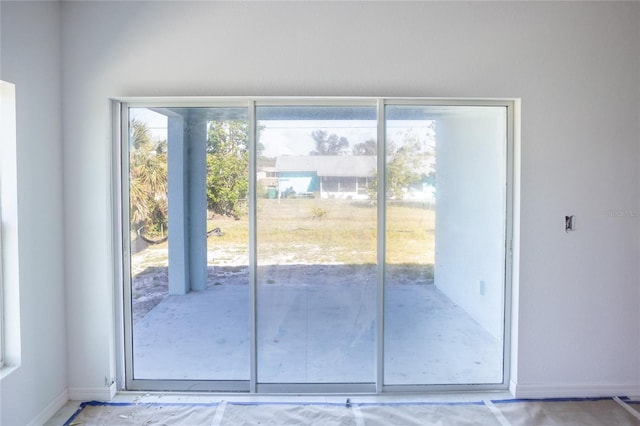3430 Sarto Ln, Rotonda West, FL 33947 - doorway to outside featuring baseboards