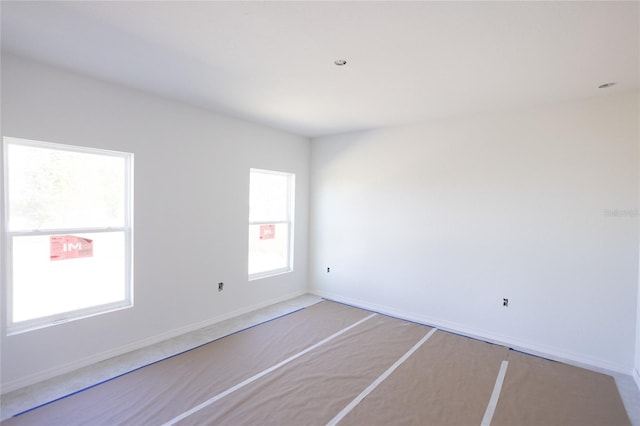 unfurnished room featuring baseboards