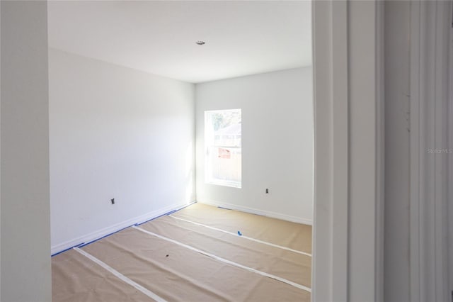 spare room featuring baseboards