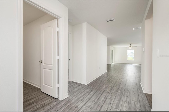 corridor with light hardwood / wood-style flooring