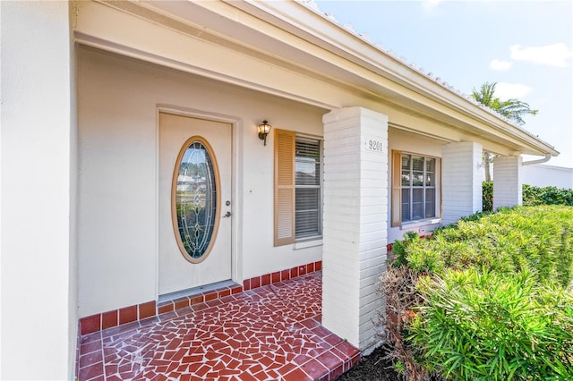 view of exterior entry with covered porch