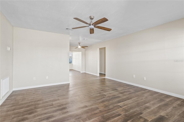 unfurnished room with ceiling fan and dark hardwood / wood-style flooring