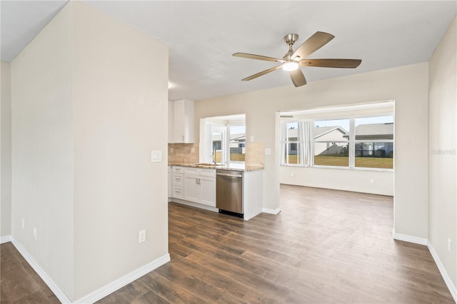 kitchen with ceiling fan, tasteful backsplash, dark hardwood / wood-style flooring, stainless steel dishwasher, and white cabinets