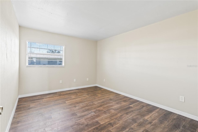 spare room featuring dark hardwood / wood-style flooring