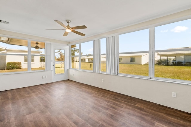 unfurnished sunroom featuring ceiling fan