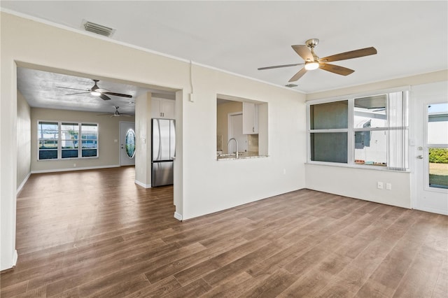 9201 40th Way N, Pinellas Park, FL 33782 - empty room featuring a ceiling fan, dark wood-style flooring, and crown molding