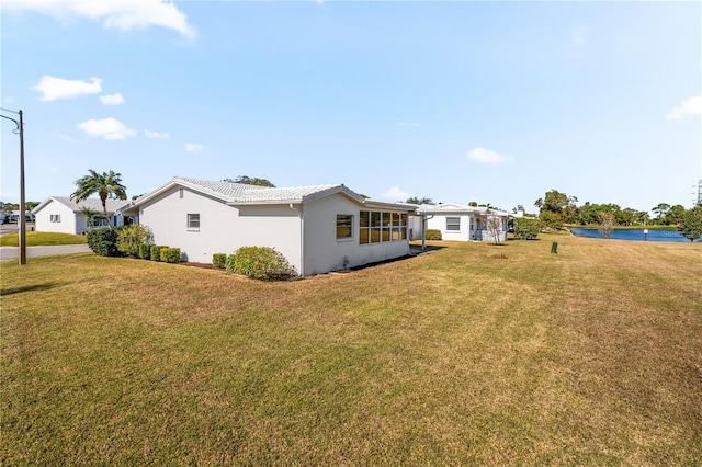 view of property exterior with a lawn