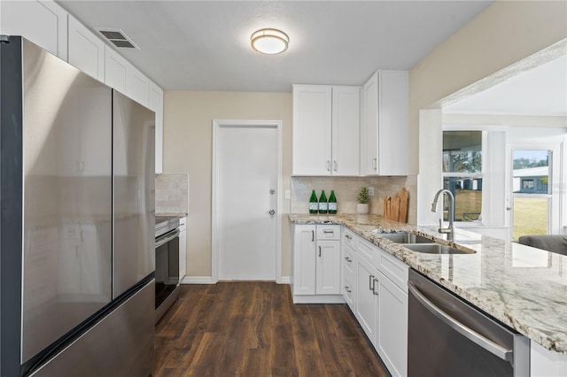 9201 40th Way N, Pinellas Park, FL 33782 - kitchen featuring stainless steel appliances, backsplash, dark wood-style flooring, and white cabinetry