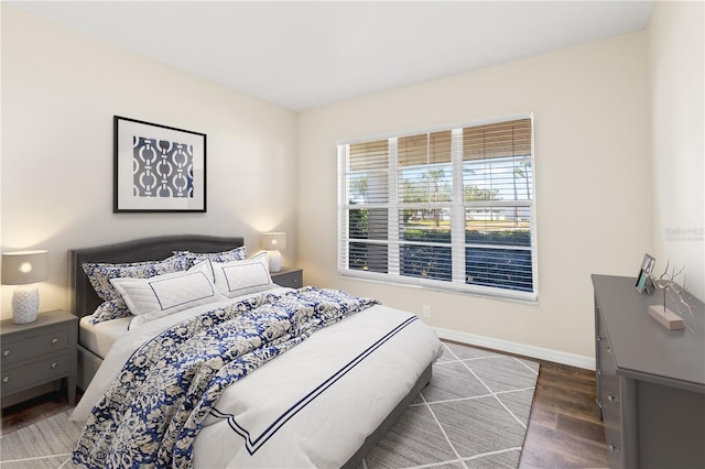 bedroom with dark hardwood / wood-style floors