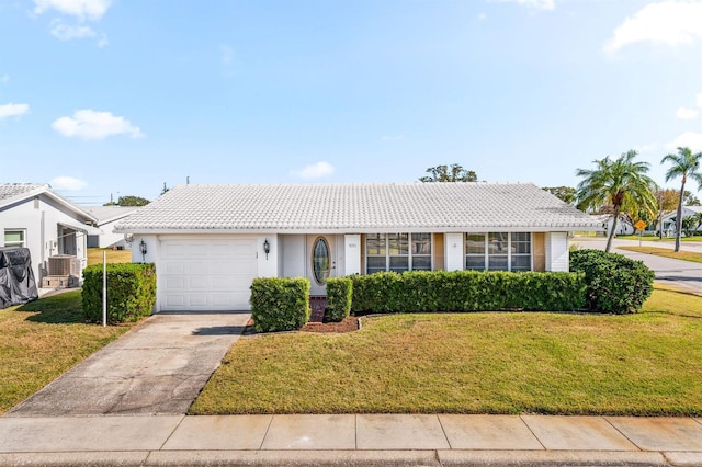 9201 40th Way N, Pinellas Park, FL 33782 - view of front of house featuring a tile roof, a garage, a front yard, and concrete driveway