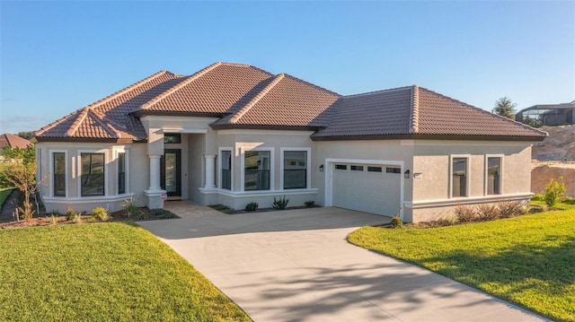 mediterranean / spanish-style house with a garage and a front yard