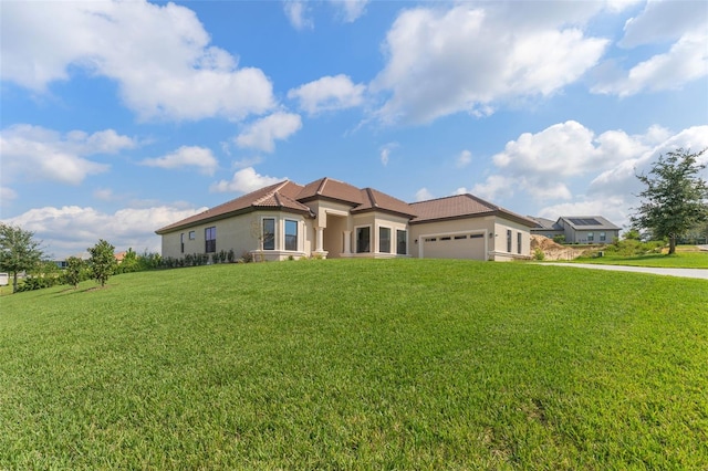 view of front of home featuring a garage and a front lawn