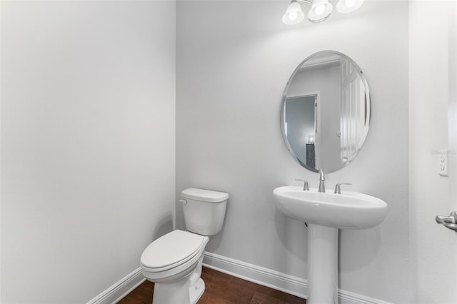 bathroom with hardwood / wood-style flooring, sink, and toilet