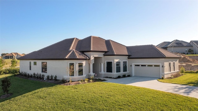 view of front of home with a front yard and a garage