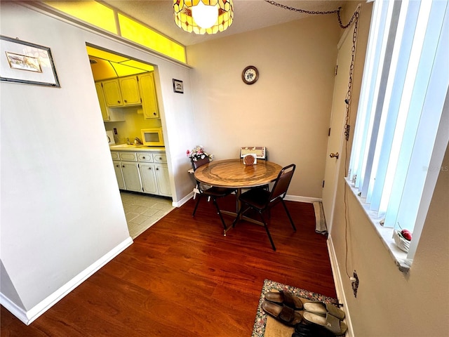 dining space featuring light hardwood / wood-style floors and a textured ceiling