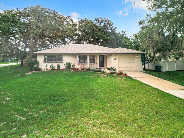 1237 N Lion Cub Pt, Lecanto, FL 34461 - ranch-style home featuring an attached garage, stucco siding, and driveway