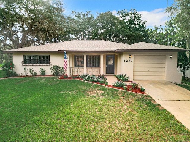 single story home with a front lawn, covered porch, and a garage