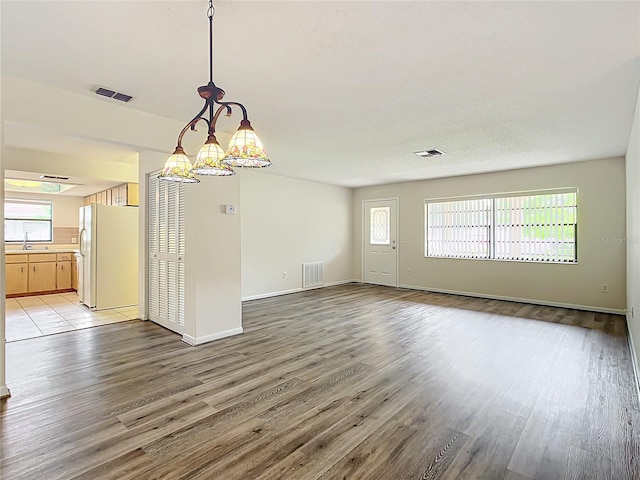 interior space featuring light hardwood / wood-style flooring, a healthy amount of sunlight, and sink