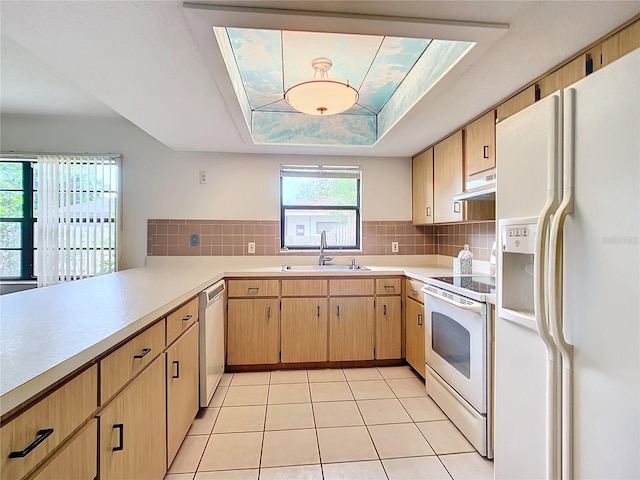 kitchen featuring white appliances, sink, decorative backsplash, light tile patterned floors, and light brown cabinetry