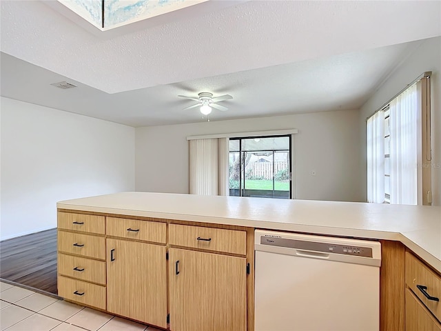 kitchen with dishwasher, ceiling fan, a textured ceiling, light brown cabinetry, and light hardwood / wood-style floors