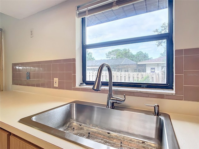 room details featuring tasteful backsplash and sink