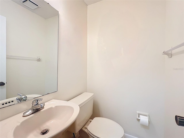 bathroom featuring toilet and sink