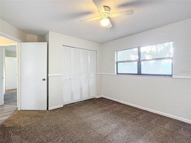 unfurnished bedroom with carpet, a textured ceiling, a closet, and ceiling fan