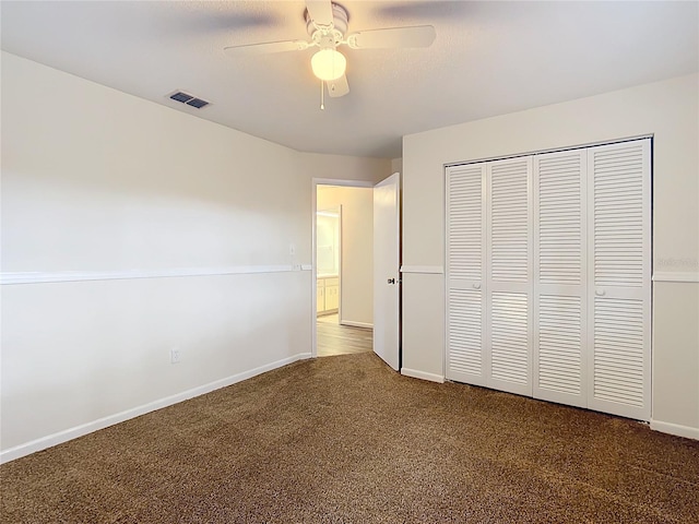 unfurnished bedroom with carpet floors, a closet, and ceiling fan