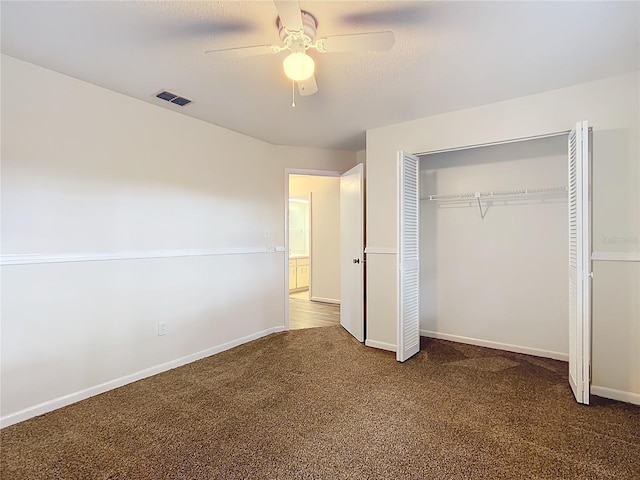 unfurnished bedroom with carpet flooring, ceiling fan, and a closet