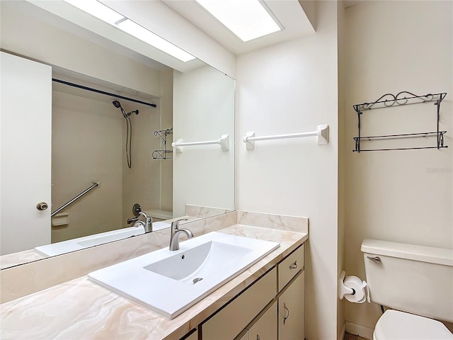 full bathroom with vanity, tiled shower / bath combo, and toilet