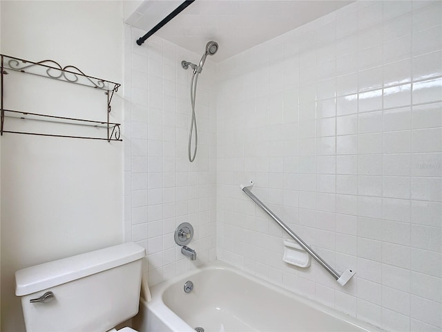 bathroom with tiled shower / bath combo and toilet