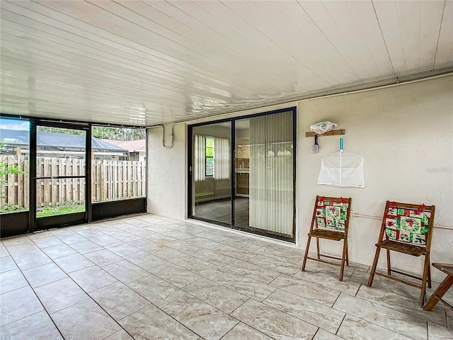 unfurnished sunroom with wood ceiling