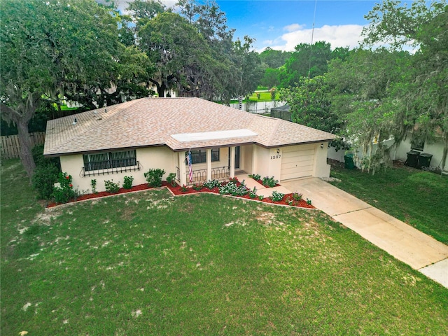 ranch-style house with covered porch, a garage, and a front yard